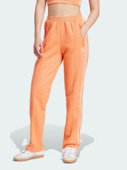 Adidas Spodnie dresowe w kolorze pomarańczowym rozmiar: XXS. Pomarańczowe spodnie dresowe damskie Adidas, xxs, bez wzorów, z dresówki. Za 114.44 zł.
