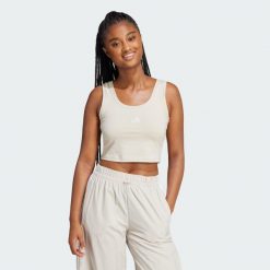 Koszulka Essentials Small Logo Cotton Lifestyle Tank. Białe koszulki damskie Adidas, l, bez wzorów, bez kołnierzyka, bez ramiączek. W wyprzedaży za 53.97 zł.