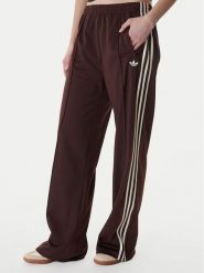 Adidas Spodnie dresowe Firebird KG3706 Brązowy Loose Fit. Brązowe spodnie dresowe damskie Adidas, s, bez wzorów, z dresówki. Za 299.99 zł.