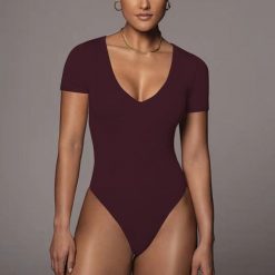 Body z krótkim rękawem i dekoltem V elastyczne Ieteke. Białe body i gorsety Intica, bez wzorów. Za 109.00 zł.