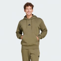 Bluza polarowa Essentials Feelcozy. Czarne bluzy damskie Adidas, m, bez wzorów, z bawełny, z kapturem. Za 219.00 zł.