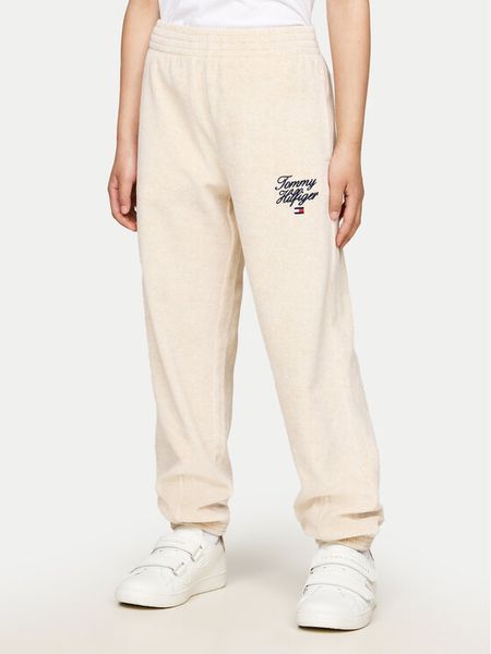 Tommy Hilfiger Spodnie dresowe Script Velour KG0KG08221 Beżowy Regular Fit. Brązowe spodnie dresowe dziewczęce Tommy Hilfiger, bez wzorów, z bawełny. Za 159.99 zł.