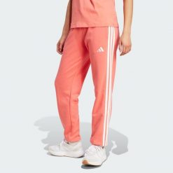 Spodnie Essentials 3-Stripes French Terry Cuffed. Białe spodnie sportowe damskie Adidas, m, bez wzorów, z materiału, na fitness i siłownię. W wyprzedaży za 135.78 zł.
