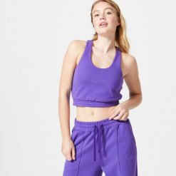 Koszulka bez rękawów damska Domyos Gym & Pilates 520 Crop. Fioletowe koszulki damskie DOMYOS, m, bez wzorów, z bawełny, bez kołnierzyka, bez ramiączek. Za 99.99 zł.