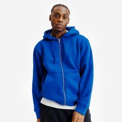 Bluza na suwak unisex Elementals. Niebieskie bluzy damskie Decathlon, uniwersalny, bez wzorów, z bawełny, z kapturem. Za 199.99 zł.