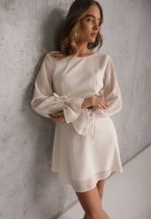 Beżowa Sukienka Vices Ozdobiona Transparentnymi Rękawami i Kropkami Celziva. Brązowe sukienki damskie Renee, bez wzorów, z koronki, eleganckie, bez ramiączek. Za 119.99 zł.