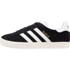 Adidas Originals GAZELLE Tenisówki i Trampki core black/white/gold metallic. Czarne buty sportowe dziewczęce Adidas Originals, z materiału. W wyprzedaży za 194.65 zł.