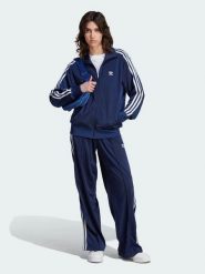 Adidas Spodnie dresowe "Firebird" w kolorze granatowym rozmiar: XS. Niebieskie spodnie dresowe damskie Adidas, xs, bez wzorów, z dresówki. Za 127.65 zł.