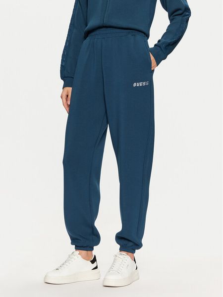 Guess Spodnie dresowe V4BB13 K7UW2 Niebieski Regular Fit. Niebieskie spodnie dresowe damskie Guess, m, z aplikacjami, z dresówki. Za 189.99 zł.