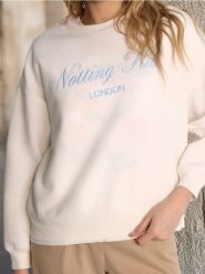 Bluza z napisem - kremowy. Białe bluzy damskie Sinsay, l, bez wzorów, bez kaptura. W wyprzedaży za 19.99 zł.