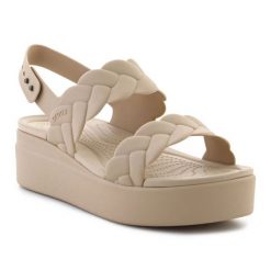 Sandały Crocs Brooklyn Woven Low Wedge 209977-212 beżowy. Brązowe sandały damskie bez wzorów, bez obcasa, na koturnie, bez zapięcia. Za 367.32 zł.