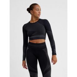 Damska bluzka treningowa bezszwowa z długim rękawem Hummel. Niebieskie bluzki damskie Hummel, bez wzorów, z materiału, sportowe, bez kołnierzyka, bez ramiączek. Za 180.50 zł.