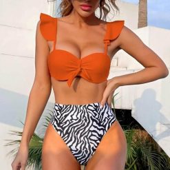 Strój kąpielowy z wysokim stanem modelujący brzuch plażowy Lidwina. Stroje jednoczęściowe Intica, bez wzorów, z materiału. Za 129.00 zł.