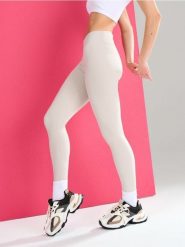 Sportowe legginsy z wycięciem V w talii Gym Hard - kremowy. Białe legginsy damskie Sinsay, l, bez wzorów. Za 39.99 zł.
