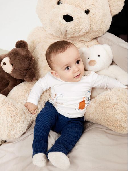 NAME IT Bluzka 13219489 Biały Regular Fit. Białe t-shirty i koszulki chłopięce Name it, bez wzorów, z bawełny, bez kołnierzyka, bez ramiączek. Za 29.99 zł.