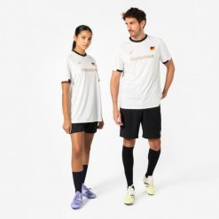 Koszulka piłkarska dla kibiców Niemcy 2026. Białe bluzki damskie KIPSTA, s, bez wzorów, z materiału, sportowe, bez kołnierzyka, bez ramiączek. Za 44.99 zł.