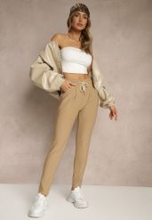 Beżowe Dopasowane Spodnie High Waist z Gumką i Wiązaniem w Talii Zelpia. Brązowe rurki damskie Renee, bez wzorów, z jeansu, z podwyższonym stanem. Za 44.99 zł.