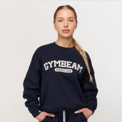 Bluza damska fitness bez kaptura niebieska Varsity. Niebieskie bluzy damskie GYMBEAM, s, bez wzorów, z bawełny, bez kaptura. Za 139.90 zł.