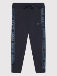 Guess Spodnie dresowe L2RQ15 K6ZS1 Granatowy Regular Fit. Niebieskie spodnie dresowe chłopięce Guess, z bawełny. Za 169.99 zł.