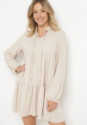 Beżowa Rozkloszowana Sukienka z Falbanką Uxaria. Brązowe sukienki damskie Born2be, z aplikacjami, eleganckie, bez ramiączek. W wyprzedaży za 93.49 zł.