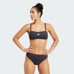 Koszulka typu bandeau Iconisea Padded. Białe koszulki damskie Adidas, bez wzorów, z materiału, bez kołnierzyka, bez ramiączek. W wyprzedaży za 99.50 zł.