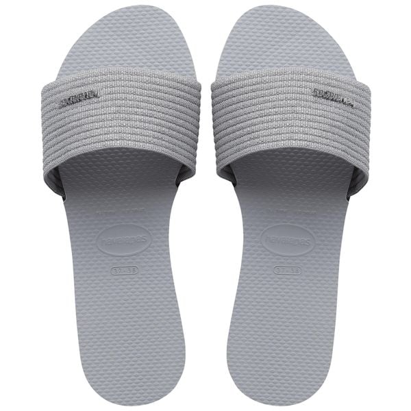 Klapki Havaianas Model 4147312 Kolor Szary. Szare klapki damskie Havaianas, bez wzorów, z materiału, bez obcasa, bez zapięcia. Za 179.99 zł.