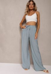 Jasnoniebieskie Szerokie Spodnie z Wiskozy i Gumką w Pasie Abyga. Niebieskie spodnie materiałowe damskie Renee, bez wzorów, z jeansu. Za 44.99 zł.