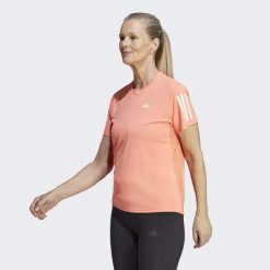 Koszulka do biegania damska Adidas Own the Run Tee. Brązowe koszulki damskie Adidas, xs, bez wzorów, z materiału, bez kołnierzyka, bez ramiączek. W wyprzedaży za 110.75 zł.