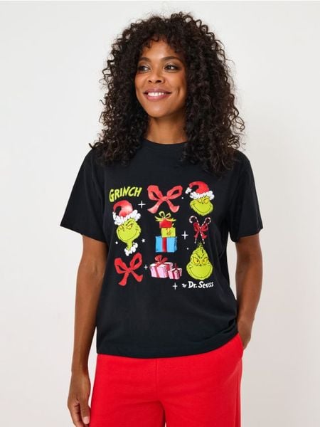 Bawełniana koszulka z nadrukiem Grinch - czarny. Czarne koszulki damskie Sinsay, l, bez wzorów, z bawełny, bez kołnierzyka, bez ramiączek. Za 39.99 zł.