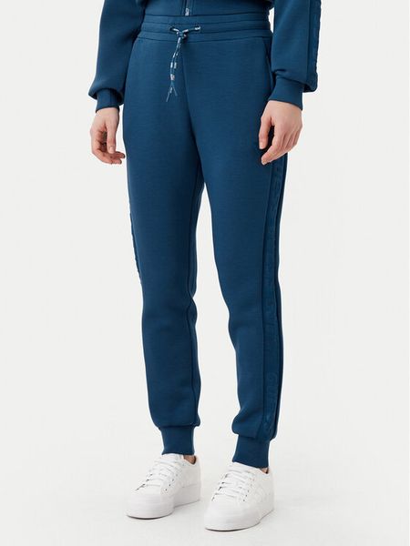 Guess Spodnie dresowe V2YB18 K7UW2 Niebieski Regular Fit. Niebieskie spodnie dresowe damskie Guess, xxs, z aplikacjami, z dresówki. Za 189.99 zł.