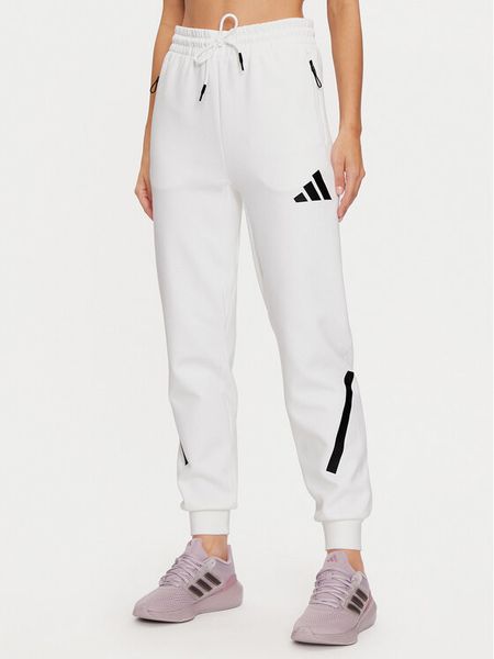 Adidas Spodnie dresowe Z.N.E. JE7843 Biały Regular Fit. Białe spodnie dresowe damskie Adidas, xs, bez wzorów, z dresówki. Za 399.99 zł.
