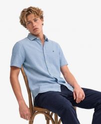 Superdry Koszula Riviera z krótkim rękawem z lnu - Blue Chalk Stripe. Niebieskie koszule damskie Superdry, na lato, m, bez wzorów, ze lnu, klasyczne, bez kołnierzyka, bez ramiączek. Za 352.05 zł.