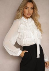 Biała Prześwitująca Koszula z Falbankami i Kwiatowym Zdobieniem przy Dekolcie Raivona. Białe koszule damskie Renee, m, z aplikacjami, z jeansu, eleganckie, bez kołnierzyka, bez ramiączek. Za 139.99 zł.