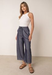 Niebieskie Spodnie Casual o Kroju Barrel z Wysokim Stanem i Ściągaczem w Talii Kosma. Niebieskie spodnie materiałowe damskie Born2be, bez wzorów, z jeansu. Za 79.99 zł.