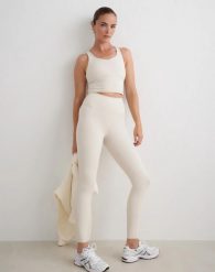 Damskie legginsy, wysoki stan, squat proof, modelujące Sculpting Fit beżowe. Brązowe legginsy damskie Aim'n, s, bez wzorów, z materiału. Za 393.00 zł.