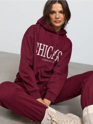 Dresowe spodnie jogger z napisem CHICAGO - bordowy. Czerwone spodnie sportowe damskie Sinsay, l, bez wzorów, z dresówki. Za 29.99 zł.