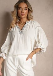 Biała Bluzka z Bawełny Ozdobiona Haftem Isdexira. Białe bluzki damskie Renee, l, bez wzorów, z bawełny, eleganckie, bez kołnierzyka, bez ramiączek. Za 59.99 zł.