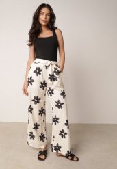 Czarno-Kremowe Spodnie o Szerokim Kroju z Wysokim Stanem w Kwiaty Ozdobione Wiązaniem Neatea. Brązowe spodnie materiałowe damskie Born2be, bez wzorów, z jeansu. Za 49.99 zł.