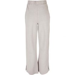Spodnie z rozcięciem dla kobiet Urban Classics Heavy Terry Garment Dye GT. Szare spodnie dresowe damskie Urban Classics, bez wzorów. Za 275.00 zł.