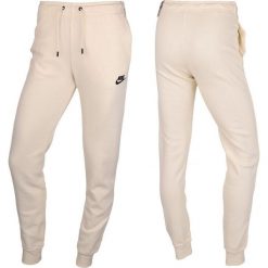 Spodnie Sportowe damskie Nike. Brązowe spodnie dresowe damskie Nike, xl, bez wzorów. Za 239.71 zł.