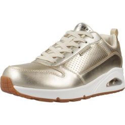 Buty SKECHERS UNO - METALLIXS Złoty. Żółte obuwie sportowe casual damskie Skechers, ze skóry ekologicznej, bez zapięcia. Za 446.09 zł.