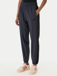 Adidas Spodnie dresowe Train Essentials 3-Stripes Woven KC5496 Czarny Regular Fit. Czarne spodnie dresowe damskie Adidas, s, bez wzorów, z dresówki. Za 219.99 zł.