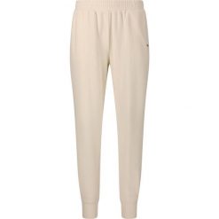 Damskie spodnie dresowe Athlecia Hecey. Białe spodnie dresowe damskie Athlecia, bez wzorów, z dresówki. Za 195.00 zł.