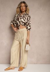 Beżowe Spodnie Typu Palazzo o Szerokim Kroju High Waist Ozdobione Wiązaniem Yaslevia. Brązowe spodnie materiałowe damskie Renee, bez wzorów, z jeansu. Za 44.99 zł.