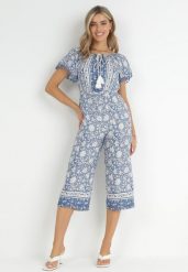Niebieski Kombinezon Hesonia. Niebieskie sukienki damskie Born2be, z aplikacjami, boho, bez ramiączek. Za 129.99 zł.