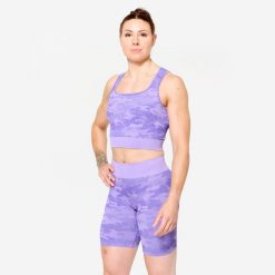 Koszulka fitness damska Domyos crop top. Fioletowe bluzki damskie DOMYOS, l, bez wzorów, z elastanu, bez kołnierzyka, bez ramiączek. Za 89.99 zł.