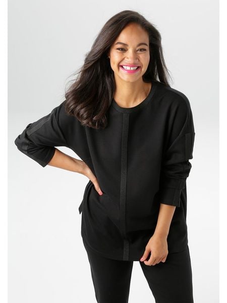 Aniston Koszulka w kolorze czarnym rozmiar: 44. Czarne koszulki damskie Aniston, bez wzorów, bez kołnierzyka, bez ramiączek. Za 82.83 zł.