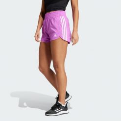 Szorty Pacer Training 3-Stripes Woven High-Rise. Białe obuwie sportowe damskie Adidas, z materiału, bez zapięcia, na fitness i siłownię. Za 124.99 zł.