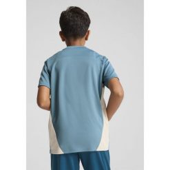 Młodzieżowa koszulka treningowa Olympique Marsylia PUMA Bold Blue Putty Beige. Brązowa bluzki damskie Puma, m, bez wzorów, bez kołnierzyka, bez ramiączek. Za 190.50 zł.