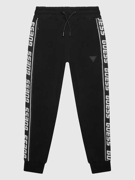 Guess Spodnie dresowe L2YQ48 K6ZS1 Czarny Regular Fit. Czarne spodnie dresowe chłopięce Guess, z bawełny. Za 289.99 zł.
